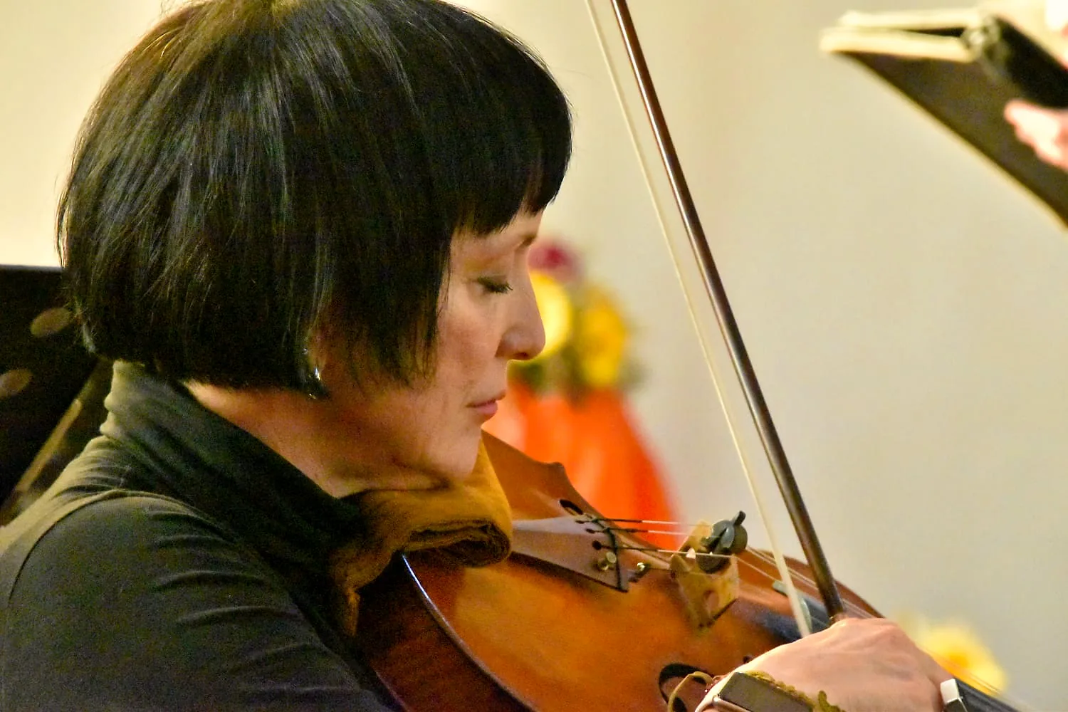 Violinist performing during a choral concert